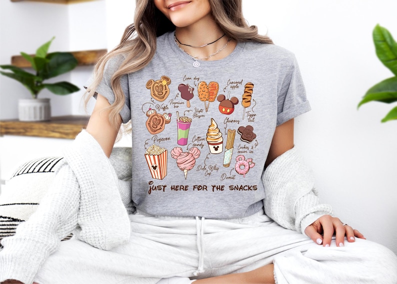 a woman sitting on a couch wearing a t - shirt