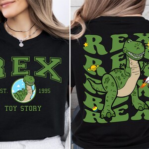 a woman wearing a t - shirt with a dinosaur on it