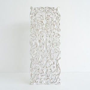 May include: White wooden wall decor with a detailed, intricate, carved floral design.