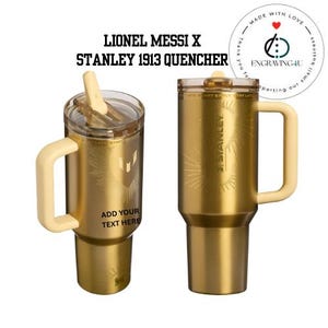 May include: Two gold-colored Stanley 1913 Quencher tumblers with cream-colored handles and lids. The tumblers have the text "LIONEL MESSI X STANLEY 1913 QUENCHER" and "ADD YOUR TEXT HERE". The Stanley logo is visible.