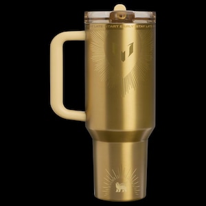 May include: A gold-colored insulated tumbler with a cream-colored handle and lid. The tumbler features an engraved design of a shield with sunburst rays and the text "START EARLY STAY LATE". A lion emblem is at the bottom.