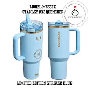 May include: Two light blue Stanley 1913 Quencher tumblers with gold accents and handles. One has a straw, the other a lid. Text includes "LIONEL MESSI X", "STANLEY 1913 QUENCHER", and "LIMITED EDITION STRIKER BLUE".