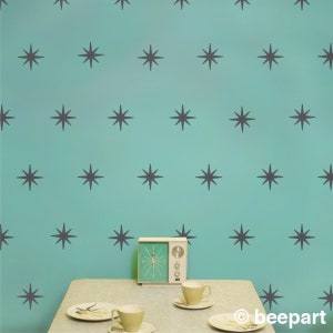 Retro starburst vinyl wall decals in dark grey.