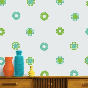 May include: A white wall with a repeating pattern of green and teal flowers. Three decorative vases in orange, teal, and yellow are on a wooden cabinet. The image includes the text "beepart".