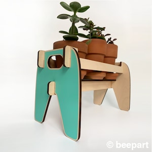 May include: A wooden plant stand with a teal blue base and three tiers. The stand is holding three terracotta pots with small succulent plants.