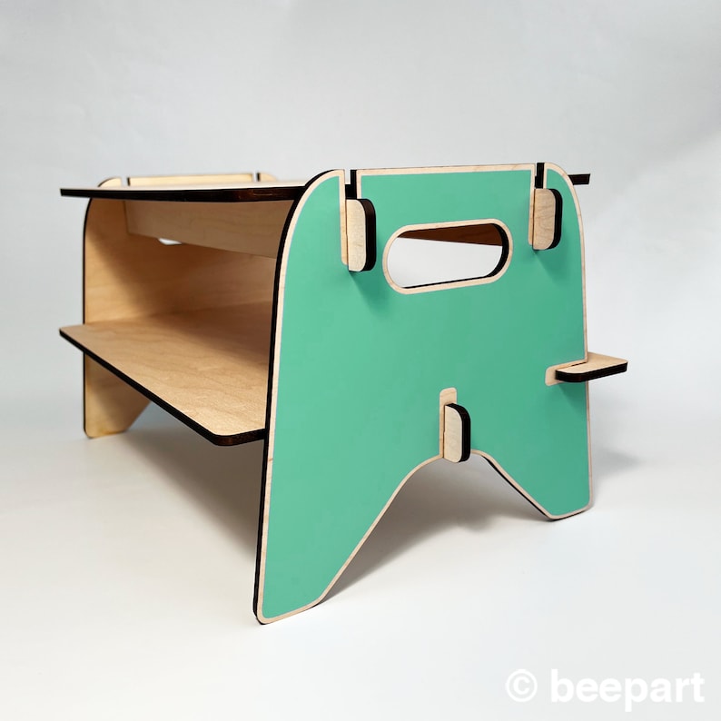 May include: A teal blue and natural wood two-tiered shelf with a handle. The shelf is made of plywood and has a modern design.