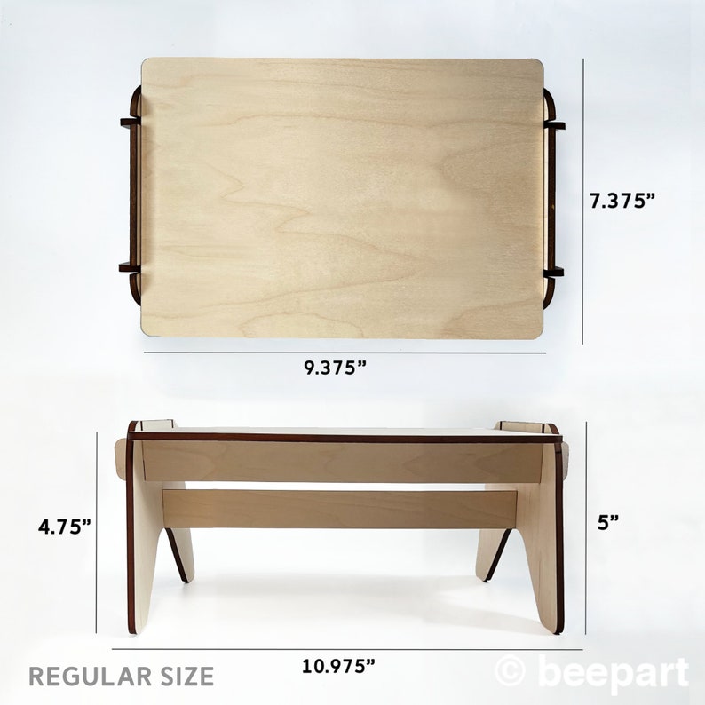 May include: A wooden laptop stand with a natural finish. The stand is 9.375 inches wide, 7.375 inches deep, and 4.75 inches tall. The stand is made of plywood and has a simple design. The stand is labeled "REGULAR SIZE" and has a copyright symbol and the word "beepart".