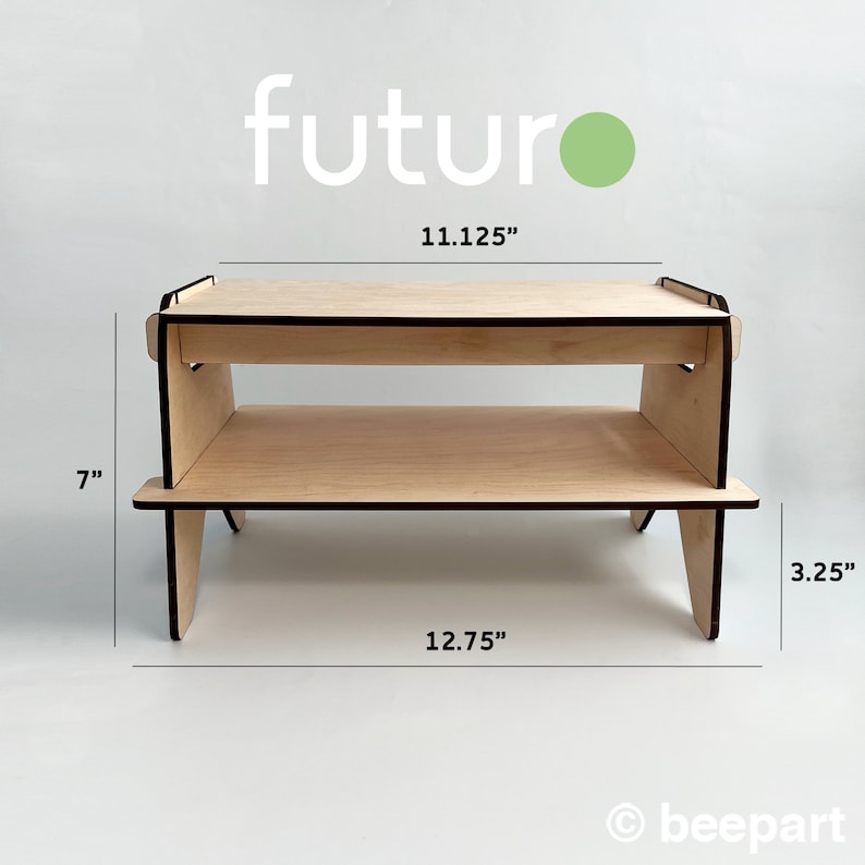 May include: A wooden two-tiered stand with a light wood finish. The stand is 11.125 inches wide, 12.75 inches long, and 7 inches tall. The top tier is 3.25 inches high.