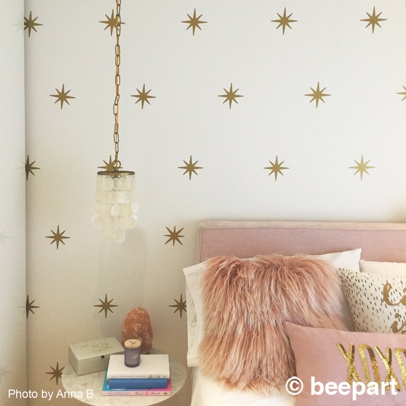 Retro starburst vinyl wall decals in metallic gold.