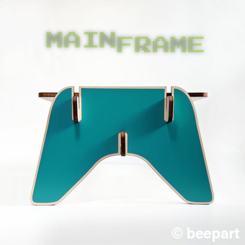 May include: A teal blue wooden game controller stand with the word "MAINFRAME" in green pixelated letters above it.