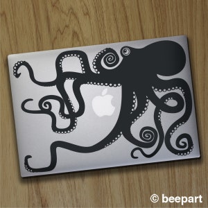 May include: A black and white silhouette of an octopus with tentacles wrapping around a silver laptop. The octopus is centred on the laptop and has a stylised design.