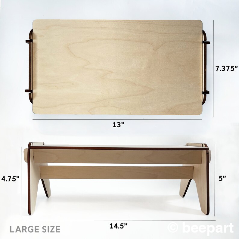May include: A wooden laptop stand with a natural finish. The stand is 13 inches wide, 7.375 inches tall, and 14.5 inches long. The stand has a large size label.