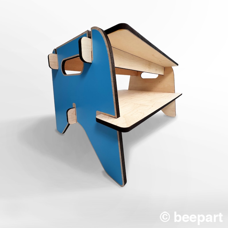 May include: A blue and natural wood step stool with two shelves. The top shelf is slightly wider than the bottom shelf. The stool is made of plywood and has a black edge.