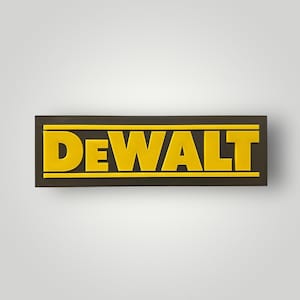 May include: A rectangular sign featuring the word "DEWALT" in bold, yellow letters. The letters are raised against a black background, with a thin yellow border. The sign is likely a brand logo.