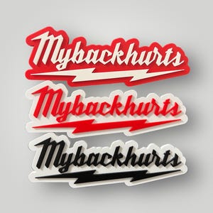 May include: Three stickers with the text "Mybackhurts". The top sticker is red with white text and a white lightning bolt. The middle sticker is red with white text and a red lightning bolt. The bottom sticker is black with white text and a black lightning bolt.