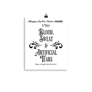 May include: A white poster with black text, held by a silver binder clip. The text reads "Managing an Eye Care Practice is HARD. It Takes BLOOD, SWEAT & ARTIFICIAL TEARS." Below the text is "(okay, and maybe some real ones too.)"