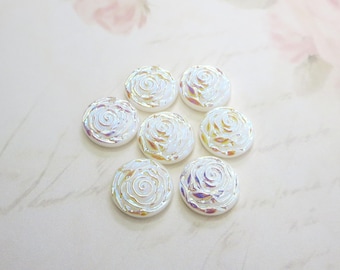 May include: Seven iridescent white pearl-like buttons with a raised rose design.