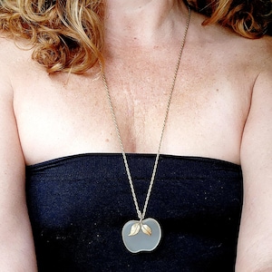 AVON frosted glass apple pendant on a gold-toned chain necklace.