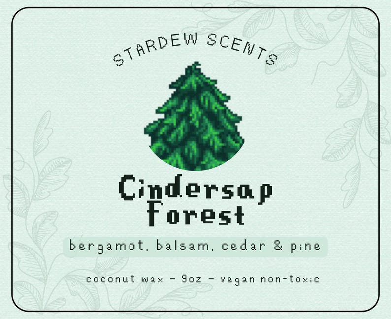 May include: A light green label with the text "STARDEW SCENTS" and "Cindersap Forest". The label features a pixelated green tree graphic. The label also lists the scent notes: bergamot, balsam, cedar & pine. It is made with coconut wax, 255g, and is vegan non-toxic.