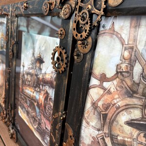 May include: A black wooden frame with a steampunk design featuring intricate gears and cogs in copper and gold tones. The frame is decorated with a vintage-style image of a steam locomotive.