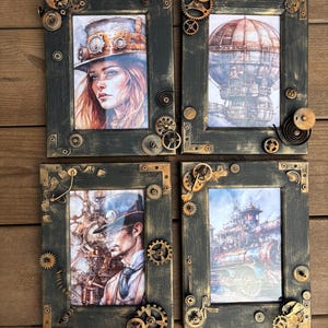 May include: Four black picture frames with gold accents and steampunk-themed artwork. The frames are decorated with gears, cogs, and other metal embellishments. The artwork includes a woman in a steampunk hat, a hot air balloon, a steampunk train, and a man in a steampunk hat.