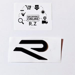 May include: Black and white logo of the letter "R" with a stylized design. The logo is on a white background.