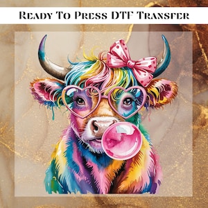 May include: A colorful DTF transfer featuring a Highland cow with heart-shaped glasses and a pink bow. The cow is blowing a bubble and has rainbow-colored fur. The text "READY TO PRESS DTF TRANSFER" is at the top.