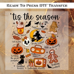May include: A DTF transfer with a Halloween theme. The design includes a witch on a crescent moon, pumpkins, bats, and the text "'tis the season." Other text includes "Pumpkin Spices," "Halloween lights," and "Baking cookies."