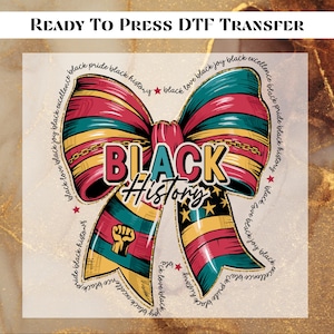 May include: A vibrant bow design with the words "BLACK HISTORY" in the center. The bow is adorned with red, black, yellow, and green stripes, and the text "READY TO PRESS DTF TRANSFER" is at the top.