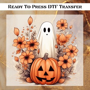 May include: A ready-to-press DTF transfer featuring a smiling ghost and a jack-o'-lantern pumpkin surrounded by orange flowers on a beige background.