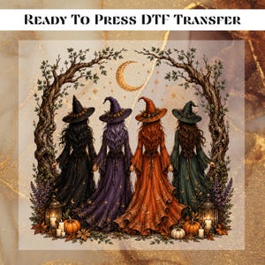 May include: A Ready To Press DTF Transfer featuring four figures in witch hats and long dresses in black, purple, orange, and green, standing under arched trees with a crescent moon, lanterns, and pumpkins on the ground in a fall setting.