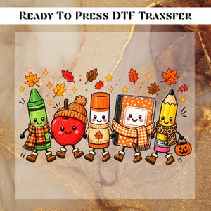 May include: A Ready To Press DTF Transfer featuring a cartoon green crayon, red apple, orange glue stick, orange notebook, and yellow pencil, all with smiling faces, wearing scarves and boots, surrounded by falling autumn leaves and stars.