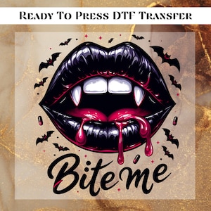 May include: Ready to press DTF transfer featuring a graphic of black lips with fangs and dripping red blood. The text "Bite me" is written in a stylized font. Bats and stars surround the lips.