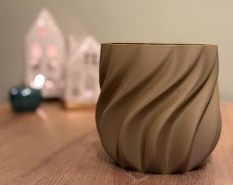 May include: A brown ceramic planter with a swirling, textured design. The planter is empty and has a smooth, rounded bottom.