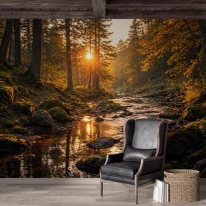 May include: A scenic wall mural depicting a sunlit forest scene with a river flowing through it. The image features tall trees, moss-covered rocks, and a bright sun. A black leather armchair and a woven basket are in the foreground.