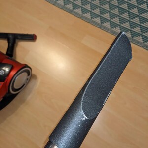 May include: A black vacuum cleaner attachment with a textured surface and a silver metal extension pole.