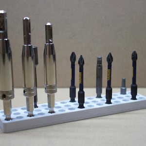 May include: A white plastic drill bit organizer with a variety of drill bits, including a few with the Irwin brand name.