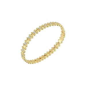May include: A gold bangle bracelet with a beaded design and small diamonds set into the beads.