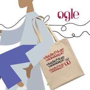 May include: A beige tote bag with the text "what the f*ck are you looking at?" in red and black. The bag has long handles and a green logo. The word "ogle" is written in red above the bag.