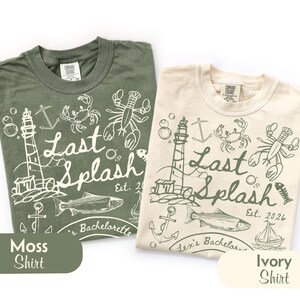 May include: Two t-shirts, one moss green and one ivory, with a nautical-themed graphic. The design includes a lighthouse, fish, crab, lobster, and the text "Last Splash Est. 2026". The shirts are labeled "Moss Shirt" and "Ivory Shirt".