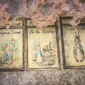 May include: Three vintage-style cards with illustrations of Peter Rabbit. The first card says "Homegrown Carrots" and features Peter Rabbit holding a carrot. The second card says "In the Garden" and features Peter Rabbit with a friend. The third card says "Peter Rabbit" and features Peter Rabbit standing alone.