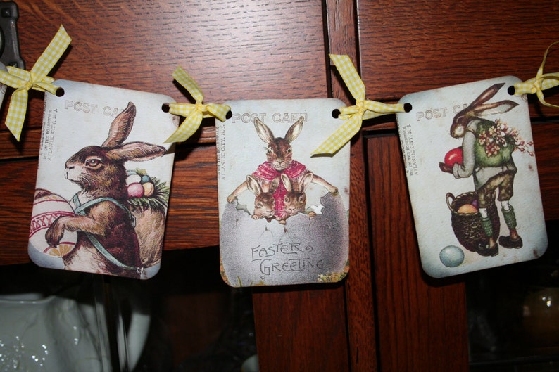 May include: Three vintage Easter cards with yellow ribbon and bunny illustrations. The cards read "Post Card" and "Easter Greeting".