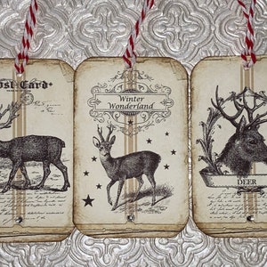 May include: Three vintage-style gift tags with a rustic brown background and white text. The tags feature illustrations of deer and the words "Post Card", "Winter Wonderland", and "Deer".