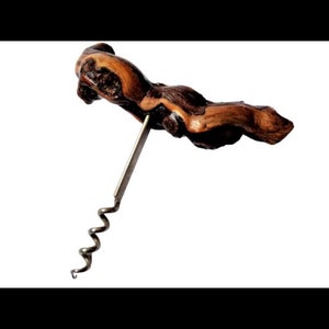 May include: A wooden corkscrew with a metal spiral. The wood is a dark brown with lighter brown streaks.