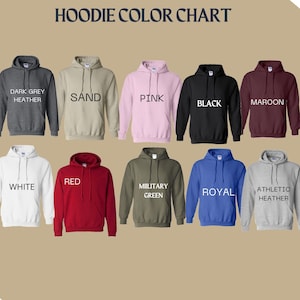 May include: Color chart showing 10 different hoodie colors. The colors are: Dark Grey Heather, Sand, Pink, Black, Maroon, White, Red, Military Green, Royal, and Athletic Heather.