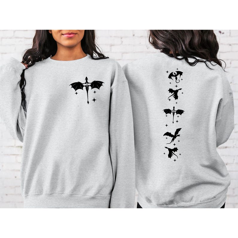 May include: A gray sweatshirt with a black dragon design on the front and a row of five black dragons on the back.