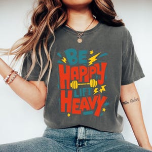 Comfort Colors® Be Happy Lift Heavy Shirt, Funny Gifts For Gym Lovers, Workout T-Shirt, Funny Weightlifting Shirt, Muscle Mommy Shirt
