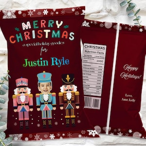 May include: Burgundy Christmas-themed gift bag with the text "MERRY CHRISTMAS" and "a special holiday goodies for Justin Ryle." Features three nutcracker illustrations and a "Nutrition Facts" label. The back says "Happy Holidays!"
