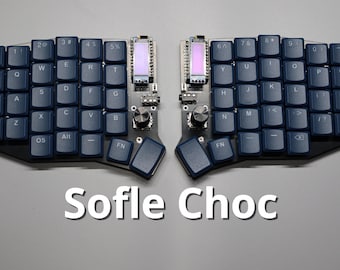 May include: A split ergonomic keyboard with dark blue keycaps. The keyboard has two halves, each with a series of keys, small screens, and dials. The text "Sofle Choc" is displayed in white at the bottom of the image.