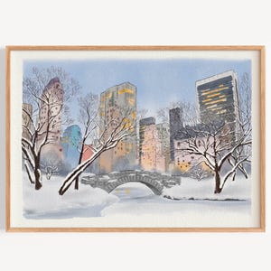 May include: Watercolor painting of a snowy Central Park scene. A stone bridge arches over a snow-covered area, with bare trees and tall buildings in the background. The artwork is framed in a light wood frame.
